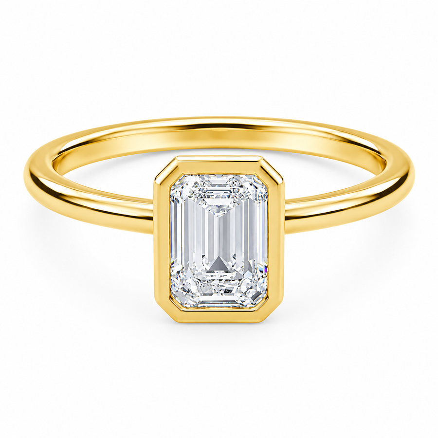 Front view of an emerald-cut lab-grown diamond bezel-set solitaire engagement ring in yellow gold