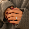 Emerald-cut lab-grown diamond bezel-set solitaire engagement ring lifestyle close-up