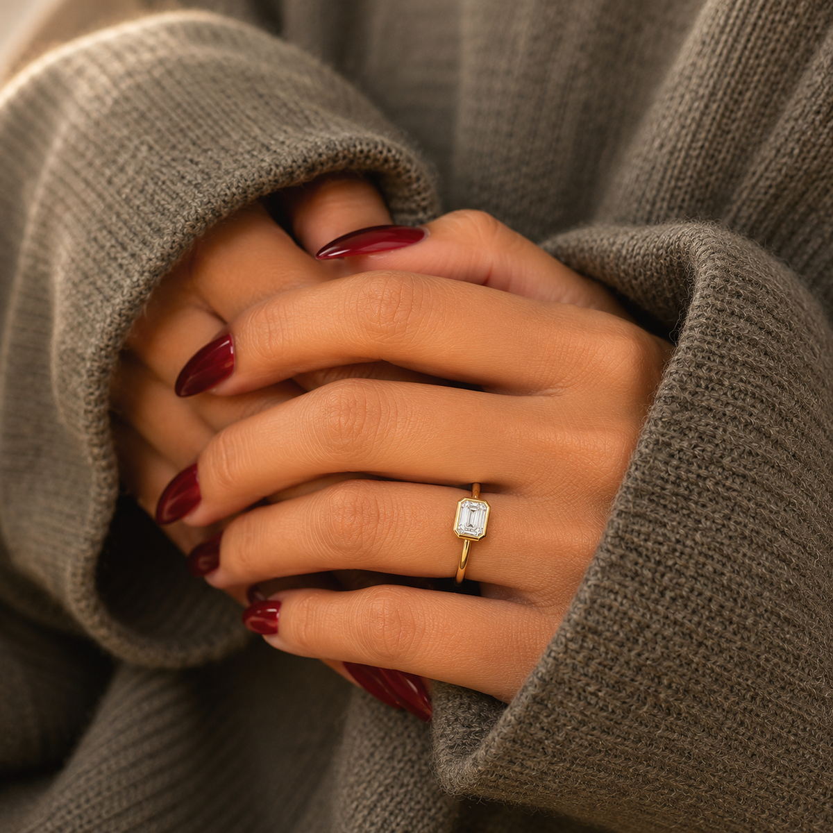 Emerald-cut lab-grown diamond bezel-set solitaire engagement ring lifestyle close-up