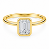 Front view of an emerald-cut lab-grown diamond bezel-set solitaire engagement ring in yellow gold