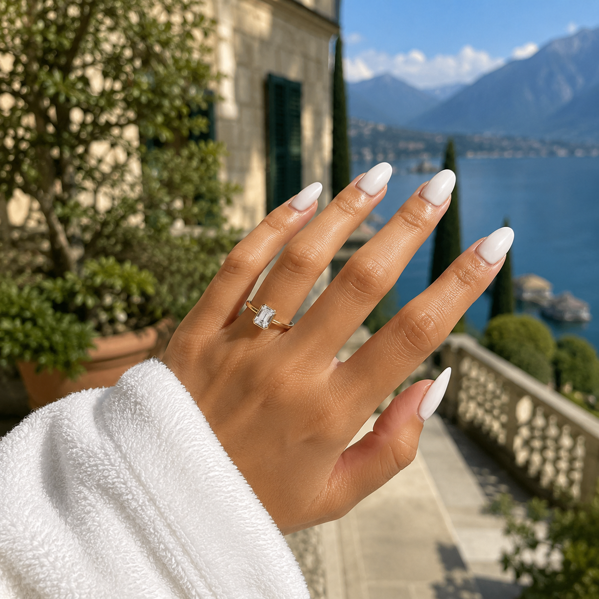 Emerald-cut lab-grown diamond bezel-set solitaire engagement ring worn on hand