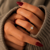 Oval-cut lab-grown diamond bezel-set solitaire engagement ring lifestyle close-up