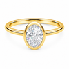 Front view of an oval-cut lab-grown diamond bezel-set solitaire engagement ring in yellow gold