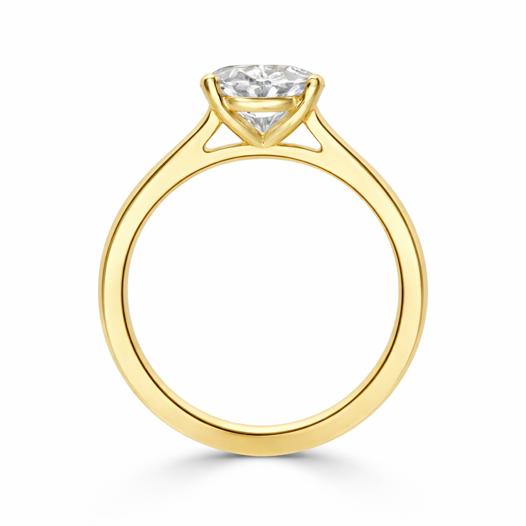 Angled view of an oval-cut lab-grown diamond cathedral solitaire engagement ring in yellow gold