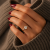 Oval-cut lab-grown diamond trilogy engagement ring lifestyle close-up