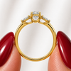 Side profile of an oval-cut lab-grown diamond trilogy engagement ring in yellow gold