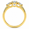 Angled view of an oval-cut lab-grown diamond trilogy engagement ring in yellow gold