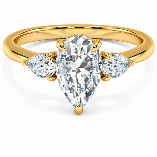Front view of a pear-cut lab-grown diamond trilogy engagement ring in yellow gold