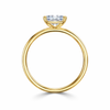 Angled view of a radiant-cut lab-grown diamond solitaire engagement ring in yellow gold
