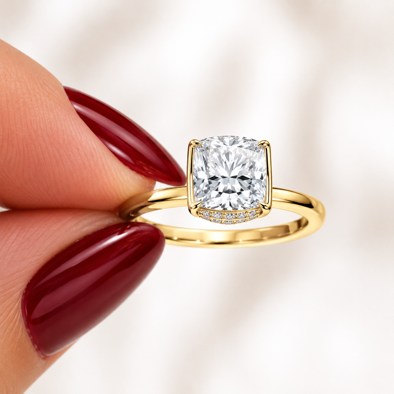 Close-up of a cushion-cut lab-grown diamond hidden halo engagement ring in yellow gold