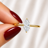 Close-up of a marquise-cut lab-grown diamond hidden halo engagement ring in yellow gold