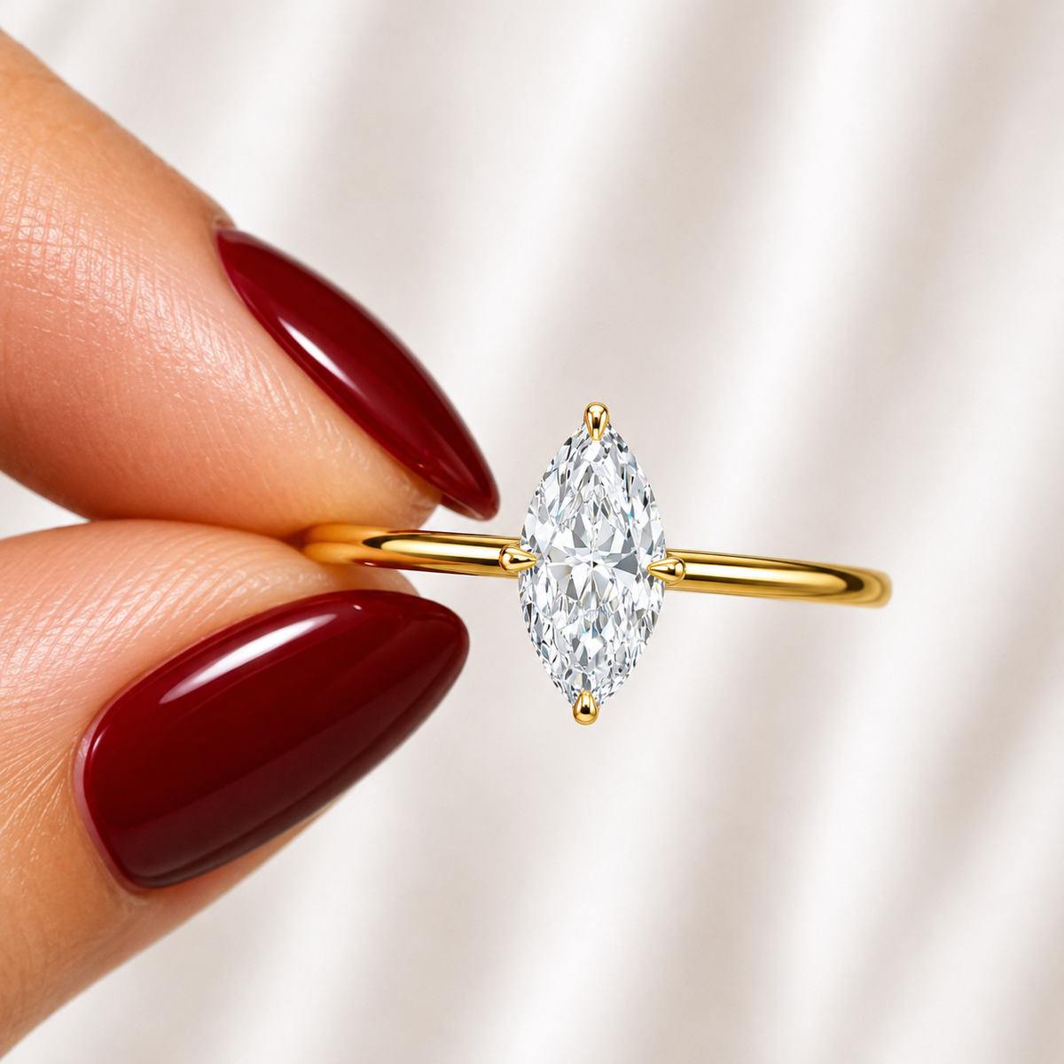 Close-up of a marquise-cut lab-grown diamond hidden halo engagement ring in yellow gold