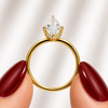 Side profile of a marquise-cut lab-grown diamond hidden halo engagement ring in yellow gold