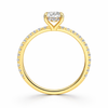 Angled view of an oval-cut lab-grown diamond hidden halo pavé engagement ring in yellow gold