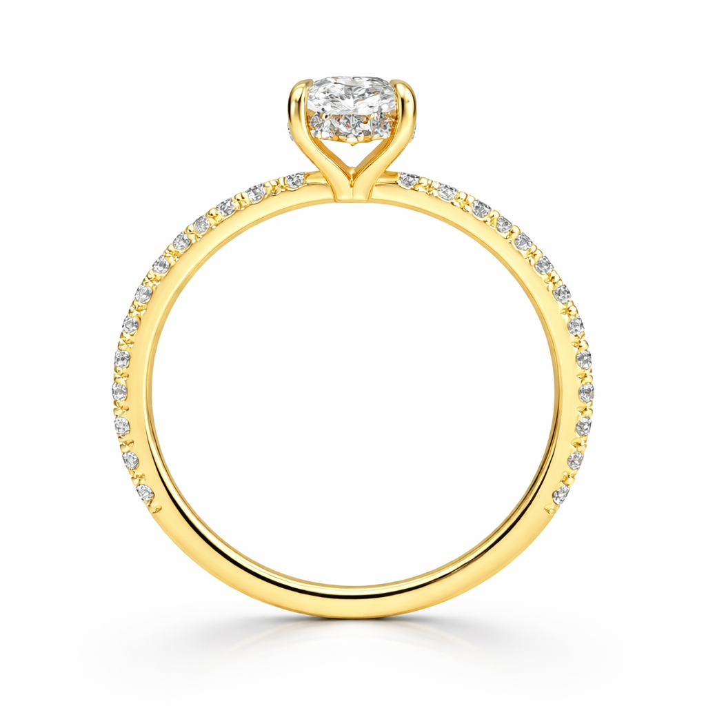 Angled view of an oval-cut lab-grown diamond hidden halo pavé engagement ring in yellow gold
