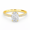 Front view of an oval-cut lab-grown diamond pavé solitaire engagement ring in yellow gold