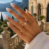 Oval-cut lab-grown diamond pavé solitaire engagement ring worn on hand