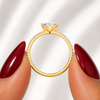 Side profile of an oval-cut lab-grown diamond pavé solitaire engagement ring in yellow gold