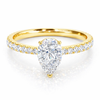 Front view of a pear-cut lab-grown diamond pavé solitaire engagement ring in yellow gold