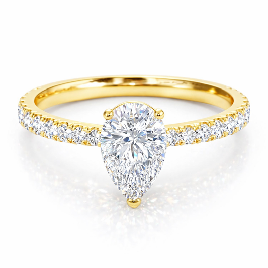 Front view of a pear-cut lab-grown diamond pavé solitaire engagement ring in yellow gold