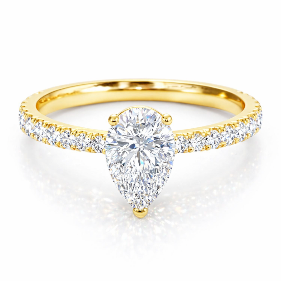 Front view of a pear-cut lab-grown diamond pavé solitaire engagement ring in yellow gold