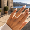 Pear-cut lab-grown diamond pavé solitaire engagement ring worn on hand
