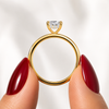 Side profile of a radiant-cut lab-grown diamond hidden halo engagement ring in yellow gold