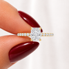 Close-up of a radiant-cut lab-grown diamond hidden halo pavé engagement ring in yellow gold