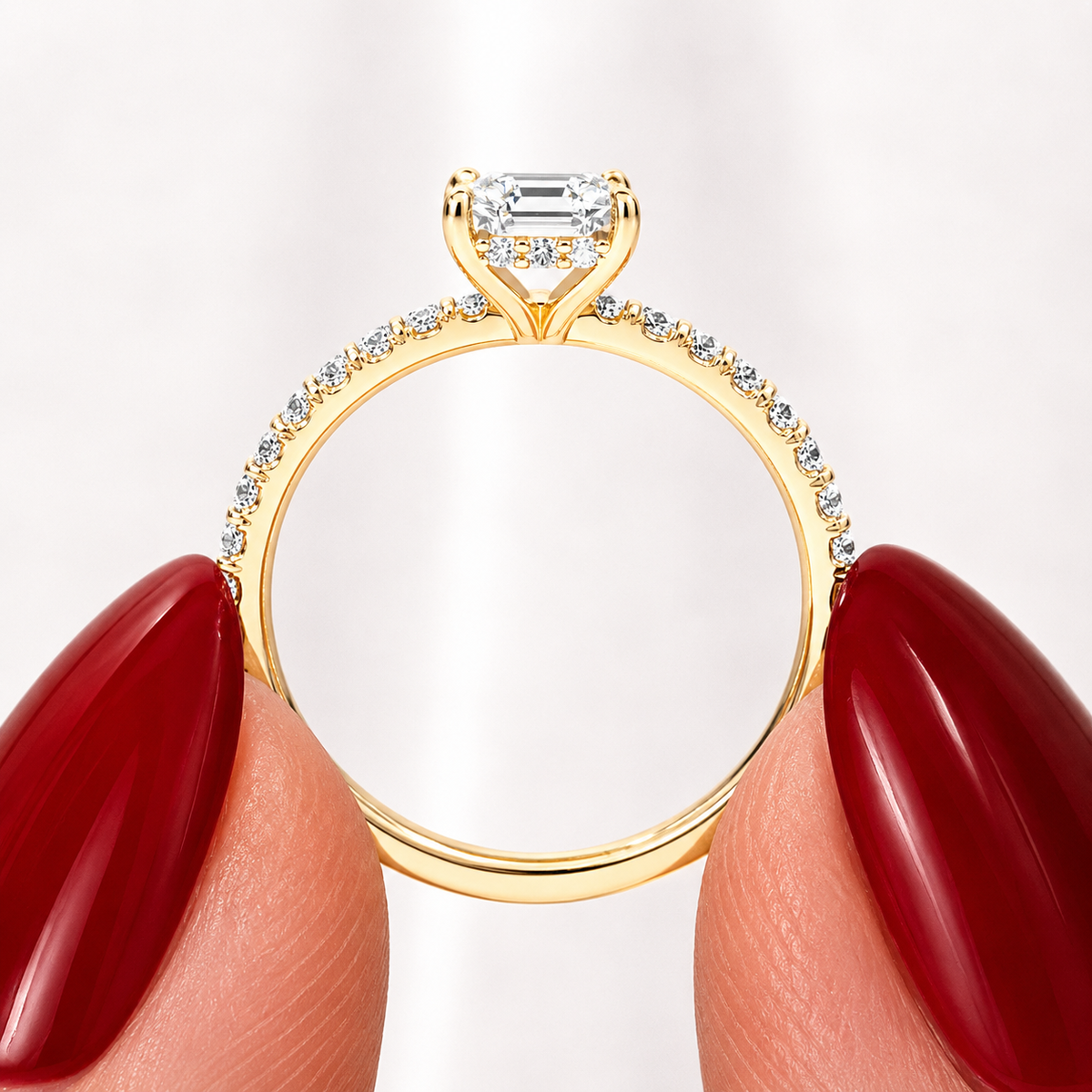 Side profile of a radiant-cut lab-grown diamond hidden halo pavé engagement ring in yellow gold